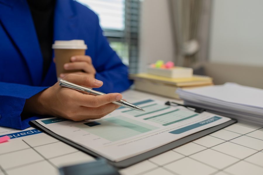 businesswoman is working in her private office with a lot of paperwork
